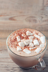 cup of hot cocoa with marshmallows on wooden background