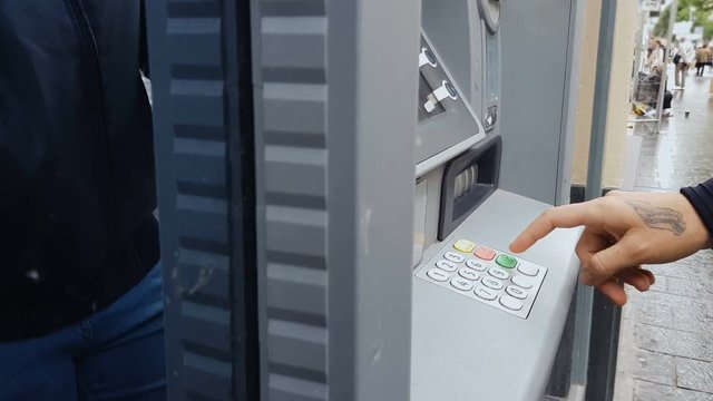 Male hand entering pin code on atm machine, cash withdrawal, payment, savings
