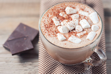 cup of hot cocoa with marshmallows on wooden background