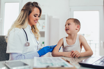 Doctor doing vaccine injection to a child, medicine, healthcare, pediatry and people concept