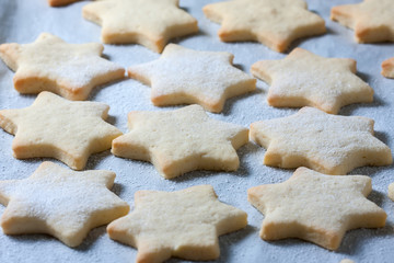 Homemade star shaped cookies on a wooden background. Christmas decoration