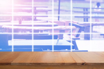 Wooden desk with blurred outdoor restaurant background