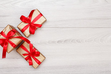 Three gift boxes on gray wooden background.