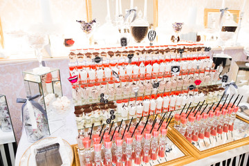 Delicious sweets on wedding candy buffet with desserts, cupcakes