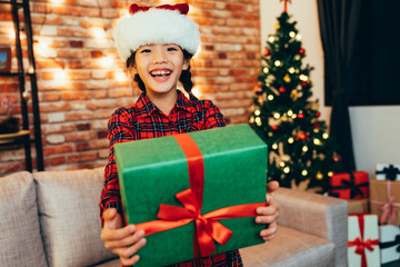 sweet christmas girl showing gift box