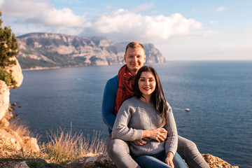 Happy couple seating outdoor near Black sea.