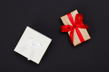 Gift boxes with ribbons on black background.