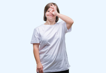 Young adult woman with down syndrome over isolated background doing ok gesture with hand smiling, eye looking through fingers with happy face.