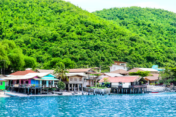 Fishing village on coast The green hills and crystal clear water