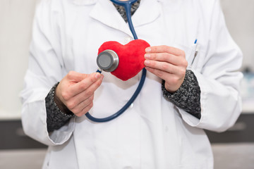 Cardiologist doctor. checking heart with stethoscope