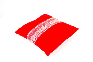 Lace ribbon on red pillow isolated on white background