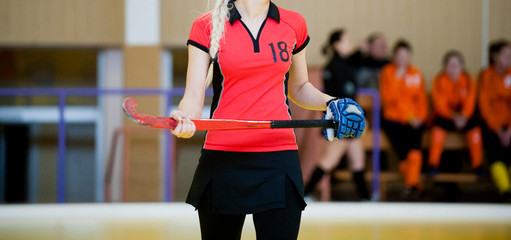 Field hockey player, in possesion of the ball, running over an astroturf pitch, looking for a team...