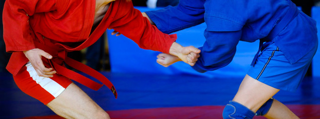 Sambo fighter attacking his opponent with leg technique