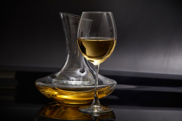 A glass full of wine and wine decanters