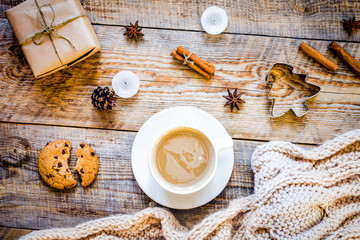 Christmas muffler with cup of cocoa wooden background top view