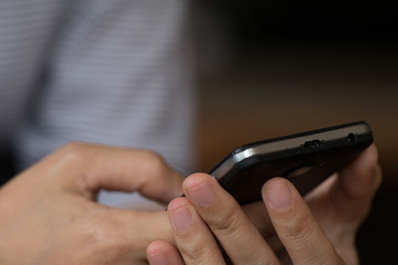 Hands of a woman using a mobile cell phone