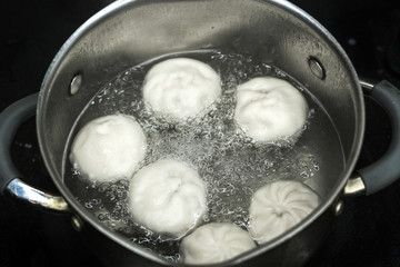 delicious dumplings are cooked in a saucepan