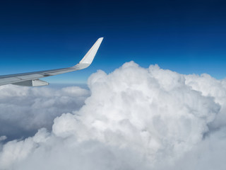 Fototapeta na wymiar Aerial view of cloud and sky with airplane wing from airplane window ,Traveling concept.