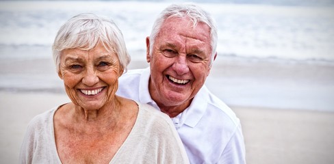 Portrait of senior couple standing on the beach