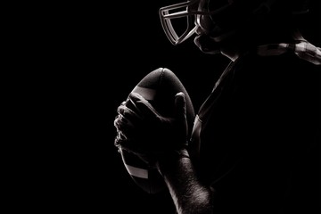 American football player standing with rugby helmet and ball © vectorfusionart