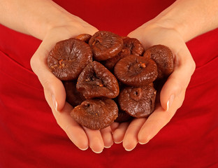 WOMAN HOLDING DIRED FIGS