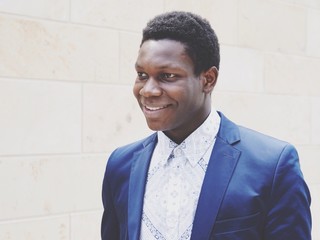happy young man of african descent smiling. faded color filter