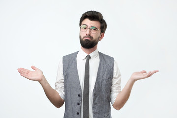 Sad hispanic man throws up his hands, as he does not know what to choose