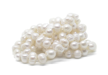 Natural cultered white pearl beads string on a white background isolated