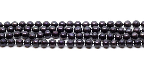 Natural cultered black pearl beads string on a white background isolated
