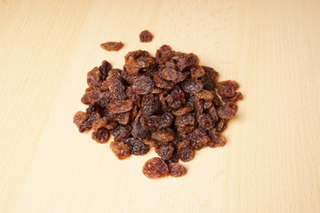 heap of raisins or sultanas on wooden table