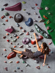 girl is climbing on the wall in training room