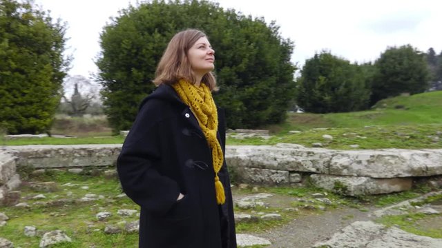 Woman looking an ancient ruins of the Italian town of Fiesole near Florence. Italian tourist attraction. Archaeological monument of Italy. Steadycam