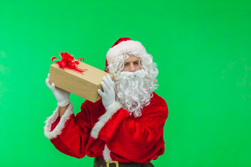 Santa Claus with gift box against chromakey. Santa interesting what's inside box