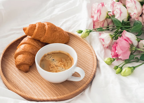 Breakfast in bed with coffee and croissants