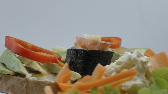 A Plate of Avocado, Suchi and Salad Toast Spinning Side View