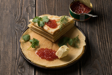 Traditional russian dish - thin pancakes with red caviar