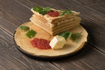 Pancakes with butter and red grained caviar
