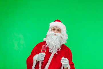 Santa Claus with a glass of champagne and looking at camera / Merry Christmas & New Year's Eve concept / chromakey