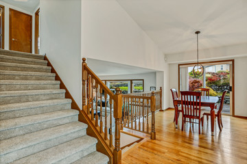Large staircase with view of living room and dining room