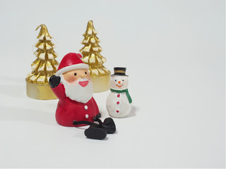 Santa Clause and snowman sitting near the golden Christmas tree candle waiting for Christmas, happy and prosperity concept