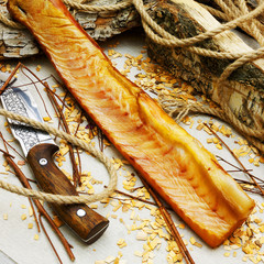 Smoked siberian fish on wooden background