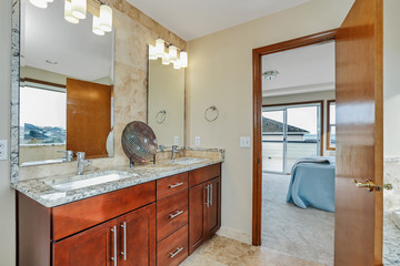 Bathroom interior with dark wood cabinets, two sinks and mirrors