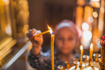 church candles burn in prayer