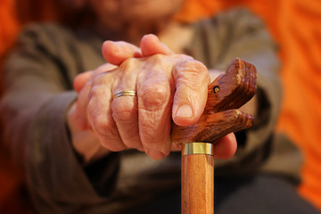 Old woman hands with cane