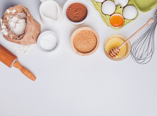 Baking ingredients on the white background, top view