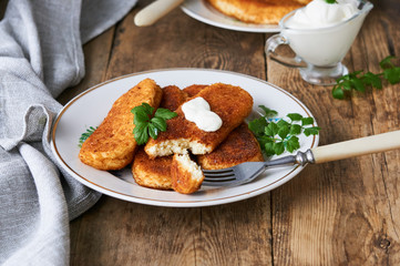 Fried cottage cheese sticks on a plate