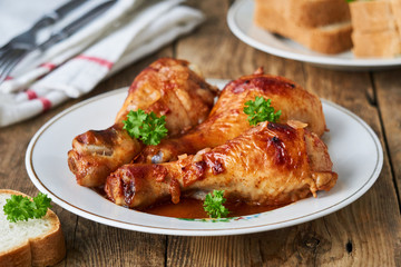 Chicken legs with tomato sauce and spices on a plate