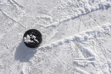 hockey puck lies on the ice in the stadium