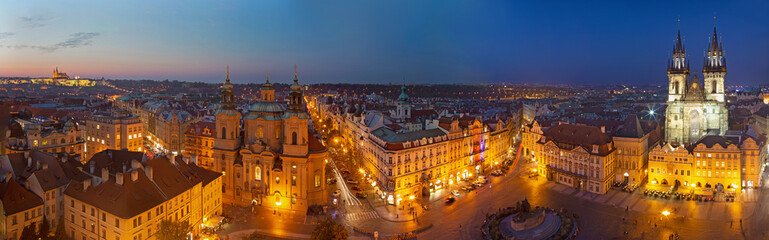 Prague - The panorama with the St. Nicholas church,   Staromestske square and the Old Town and church of Our Lady before Týn at dusk.