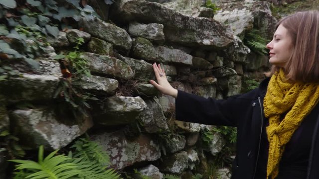Woman looking an ancient ruins of the Italian town of Fiesole near Florence. Italian tourist attraction. Archaeological monument of Italy. Steadycam